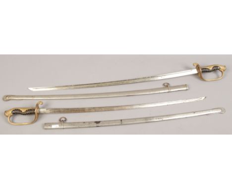 Two European dress swords in scabbards. (Blade length 73.4cm, Scabbard 77.3cm) (Blade length 69.3cm, Scabbard 72.9cm)Conditio