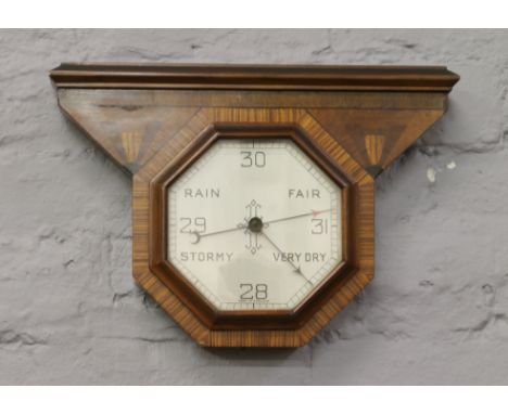 An Art Deco barometer with parquetry inlay decoration and octagonal shaped dial.