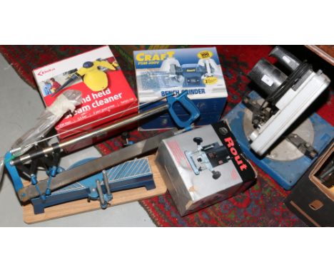 A quantity of tools to include Power Craft bench grinder, 1020 watt plunging router, and held steam cleaner, compound mitre s