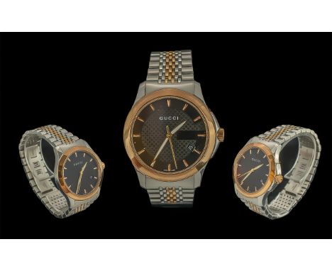 Gucci - Gents Heavy and Stylish Gold Tone and Steel Quartz Wrist Watch. Case Ref 1264. Features a Black Dial, Just / Date Dis