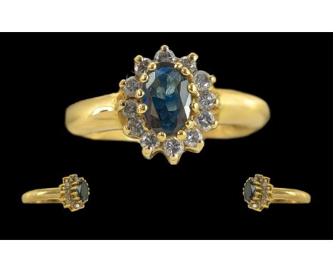 Ladies 18ct Gold Sapphire and Diamond Set Cluster Ring, Marked 750 to Interior of Shank. The Central Blue Sapphire Surrounded