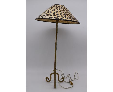 A contemporary brass effect table lamp raised on three scroll feet with leopard print shade. H.66cm 