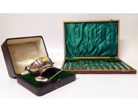 Wooden presentation box containing six fish knives and forks with silver handles, also a silver quaich and plated ladle. Cond