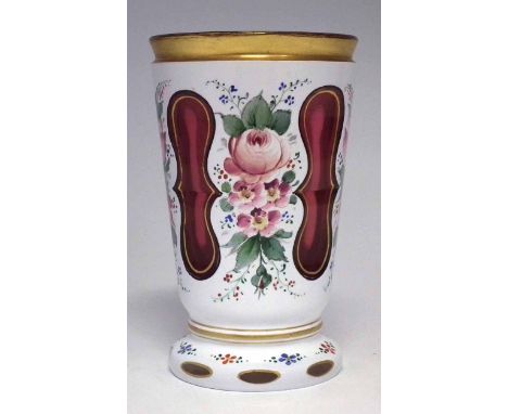 Bohemian overlay glass beaker, the cranberry and white glass body cut through and enamelled with roses, late 19th / early 20t