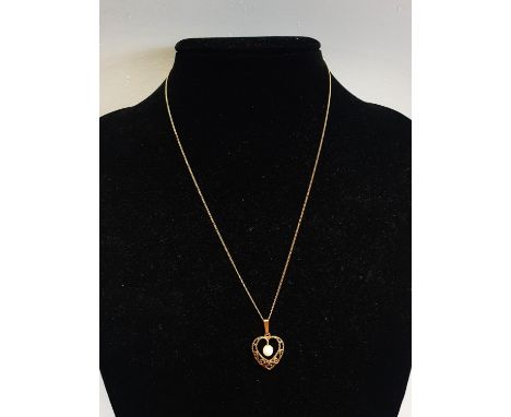 A 9ct Gold chain and pendant. 1.83g 