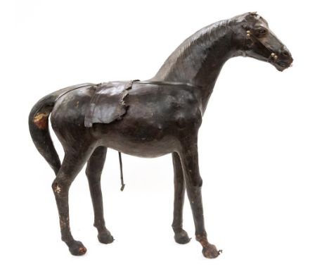 A primitive and decorative leather bound model of a standing horse, height 63cm 