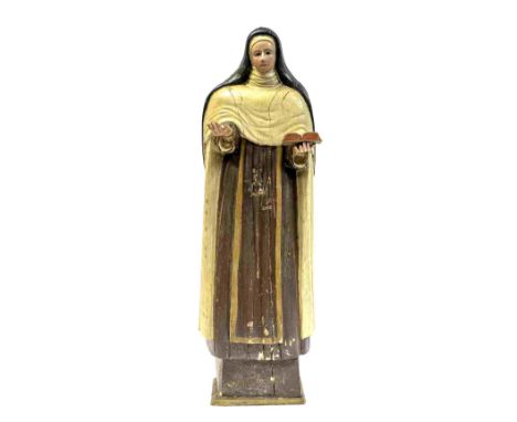 A mid 18th Century Spanish eclesiastical model of an standing Nun wearing a habit and holding an open book, carved wood with 