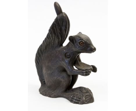 A cast iron squirrel nut cracker, spring action movement, with glass eyes, approx 19cms high