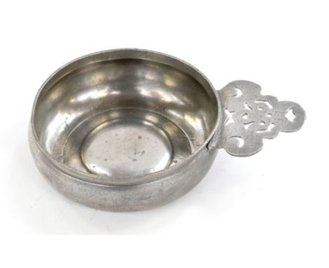 A pewter porringer with geometric crescent ear and triangular bracket, circa 1700-1755, 16 fluid ounces and owner's initials 