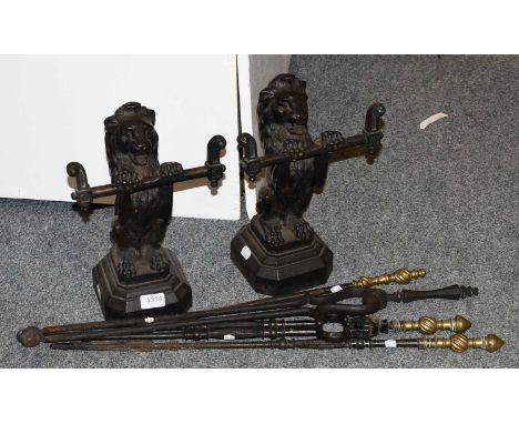 A Pair of Lion Form Andirons and Four Fire Tools 