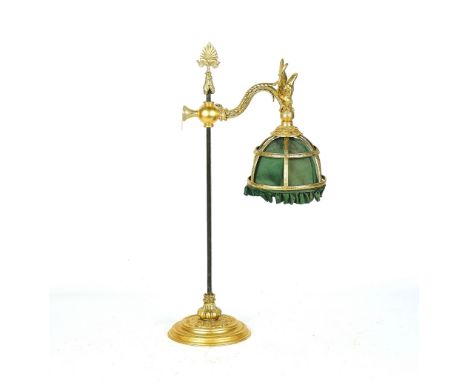 A FRENCH EMPIRE STYLE GILT-METAL ADJUSTABLE READING LIGHT20TH CENTURYWith steel rod, the shade surmounted by a winged eagle, 