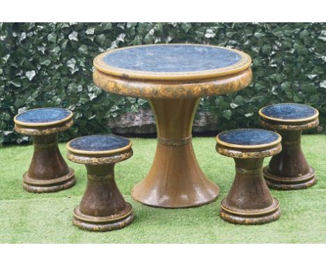 IN THE MANNER OF ROYAL DOULTONA glazed ceramic circular garden table 83cm diameter; 75cm high together with four matching sto