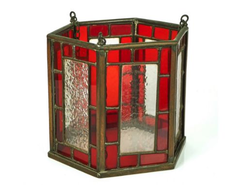 A BRASS MOUNTED LEADED STAINED GLASS HEXAGONAL HALL LANTERNEarly 20th centuryWith three hanging chains, 29cm wide; 25.5cm hig