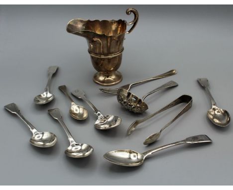 A 20th century silver helmet shaped cream jug, seven silver teaspoons, a sifter spoon, pair of sugar nips and a dessert fork.