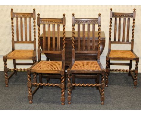 A small reproduction oak drop leaf gate leg dining table, together with a set of four 1920's cane seated oak dining chairs, o