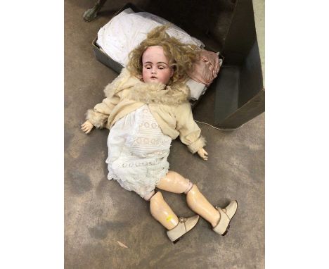 A bisque head doll and a box of dolls clothesBisque head- two hairline cracks either side of her mouth. There is also a chip 