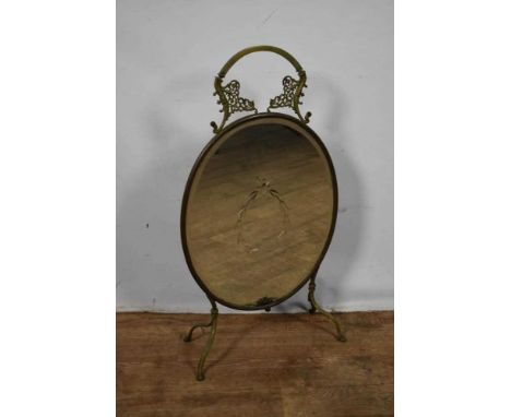 Early 20th century mirrored fire screen, oval etched bevelled glass within a pierced brass meandering frame, 80cm high. Prove