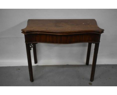 George III mahogany serpentine fronted card table, with fold-over top enclosing baize-lined interior, raised on pierced brack