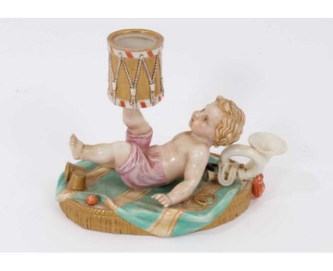 A Royal Worcester chamber candlestick, modelled as a putto with a drum, polychrome painted, mark for 1867, 11cm highRestorati