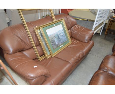 A brown leather three seater sofa