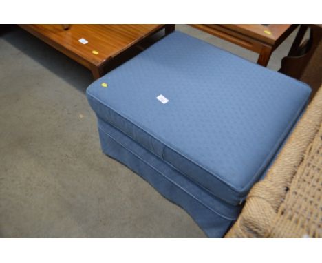 A blue upholstered pouffe 