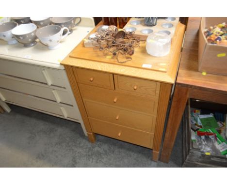 A light oak chest fitted two short over three long drawers 