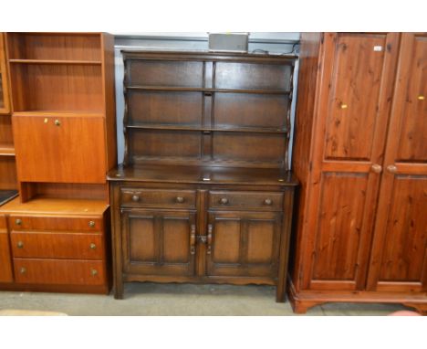 An Ercol dresser raised on cupboard base fitted two short drawers