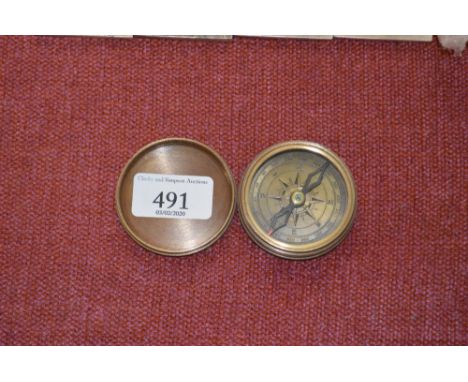 A reproduction brass cased compass (84)