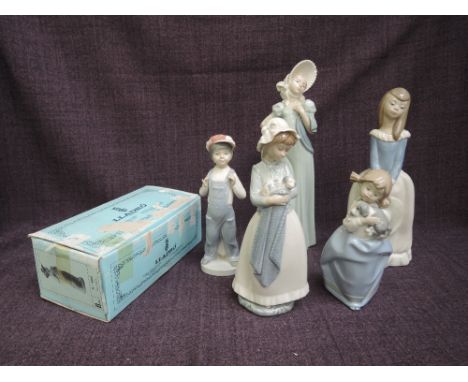 A Lladro figure, Boy From Madrid 4898, in original box along with Four Nao figurines, young ladies 