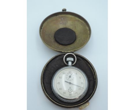 A German World War II Kreigsmarine Stopwatch-timer, with Eagle swastika on rear, in brass case decorated with Eagle and swast