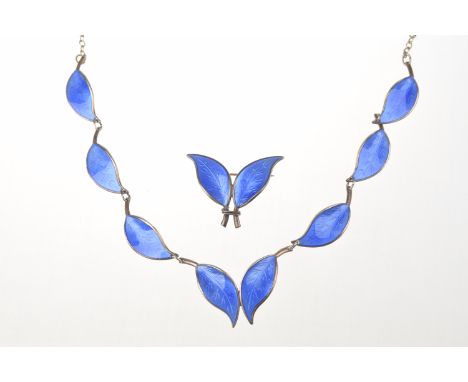 David Anderson: A silver gilt and enamel necklace and broochEach link designed as a leaf with blue enamel decoration, to a tr