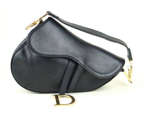 Christian Dior: A black leather saddle bagThe smooth black leather with flat shoulder strap with polished gold tone monogramm