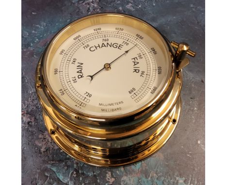 A Solent solid brass porthole clock, screw down hinged cover