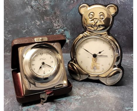 A silver mounted travel alarm clock, silver panel embossed in relief, wood backed, Ron Carr, Sheffield, 2000; a novelty silve