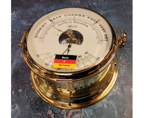 A Franz Hermle Brass Percision Barometer,&nbsp; in the style of a ships port hole, NOS, with original packaging and papers 