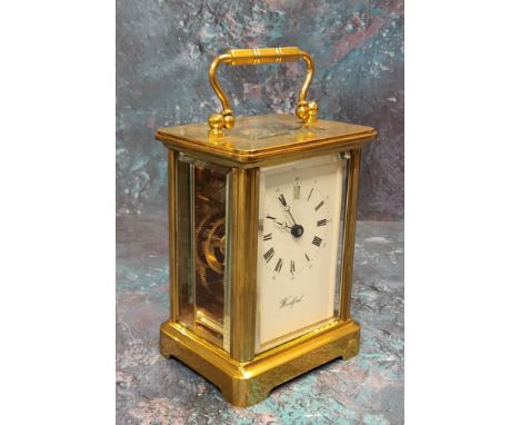 A brass carriage clock, 11 jewel movement, bevelled glass and small top panel, white dial, black Roman numerals and marked "W