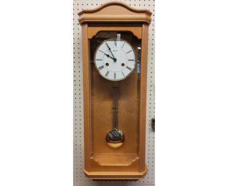 A contemporary Hermle light Beech finish wall clock, 8-day movement, single strike gong, pendulum, NOS original packaing 