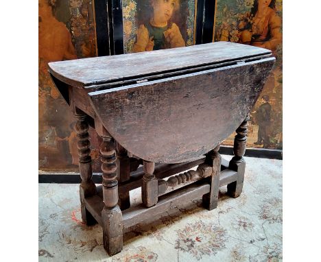 A 17th century English oak bobbin turned drop leaf tavern table c.1660 