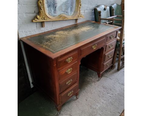 A Victorian mahogany kneehole desk, tooled green leather inlay, brass batwing escutcheons with drop swing handles, bracket fe