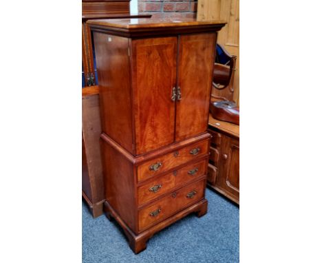 A Bel Furniture Limited flame mahogany and satinwood inlaid 'chest-on-stand' music cabinet, moulded cornice above two doors a