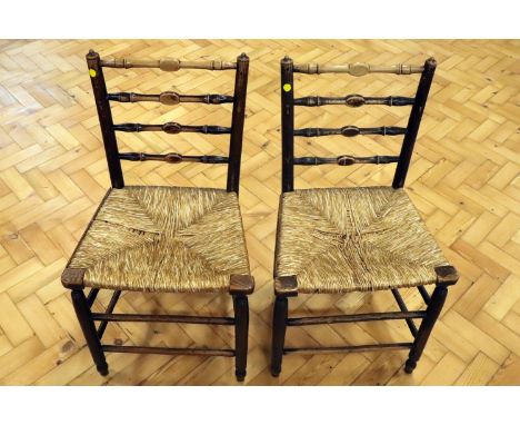 A pair of 19th Century rush-seated ladder-back chairs