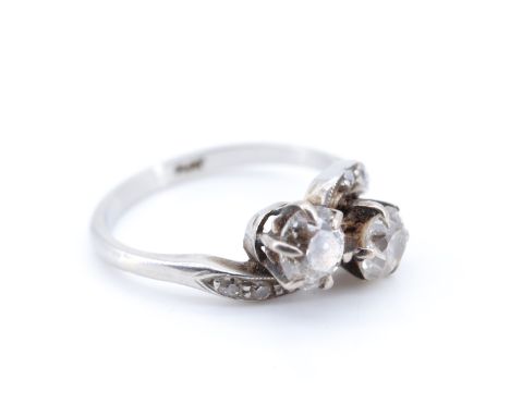 A vintage two-stone diamond ring, comprising a pair of old cut stones each of approx 0.5 ct, twist-set on a precious white me