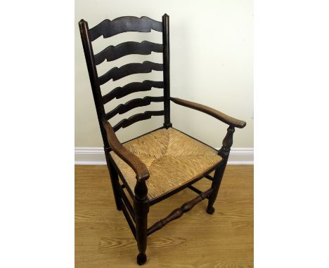 A rush-seated ladder-back armchair