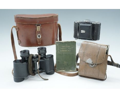 A cased Zeiss Ikon folding roll film camera, together with a cased pair of field glasses etc
