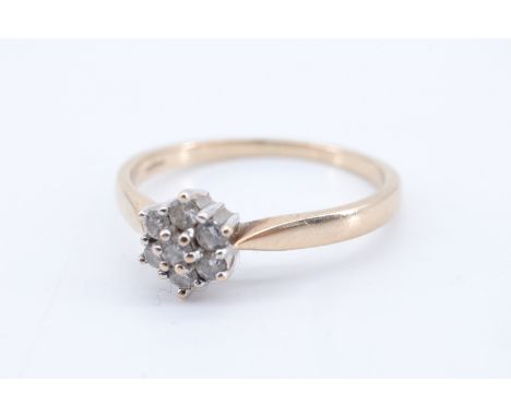 A seven stone diamond flowerhead cluster ring, the brilliants of approx 0.25 ct aggregate weight claw-set on a 9 ct gold shan