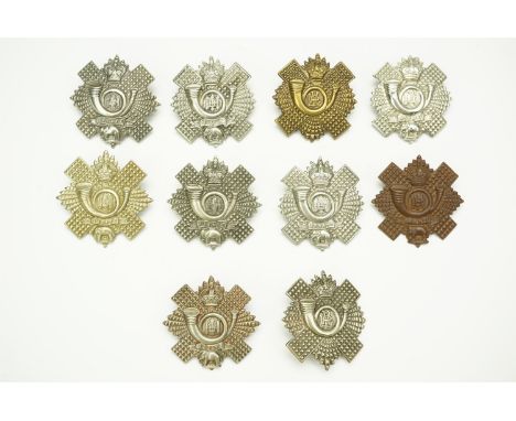 A collection of Highland Light Infantry cap badges including a 1st Volunteer Battalion example