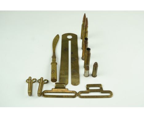 A Cambrai trench art letter knife, together with a brass button stick, cartridge cases and inert small arms rounds, belt fitt