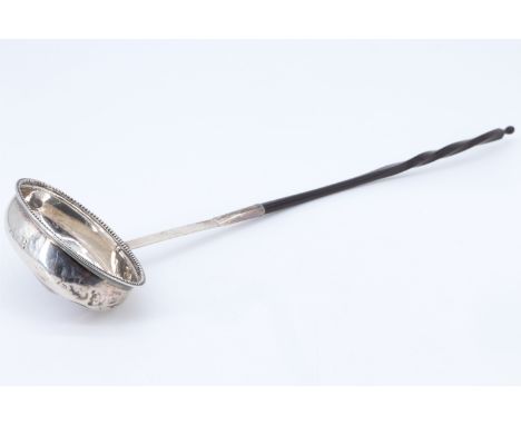 A Georgian silver toddy ladle, having a twisted baleen handle, 35 cm