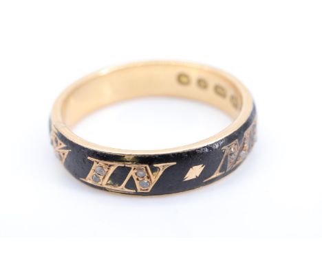 A Victorian 18 ct gold and diamond mourning ring, the band bearing 'In Memory Of' in gold and set with diamond chips, in a bl