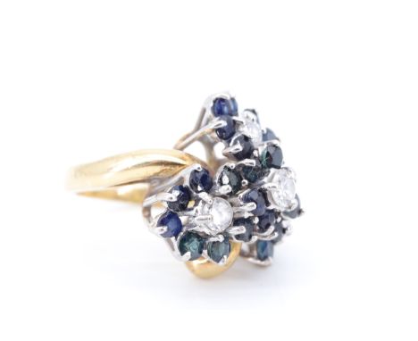 An impressive sapphire and diamond cocktail ring, comprising a terraced trefoil arrangement of four daisy setting, each a dia